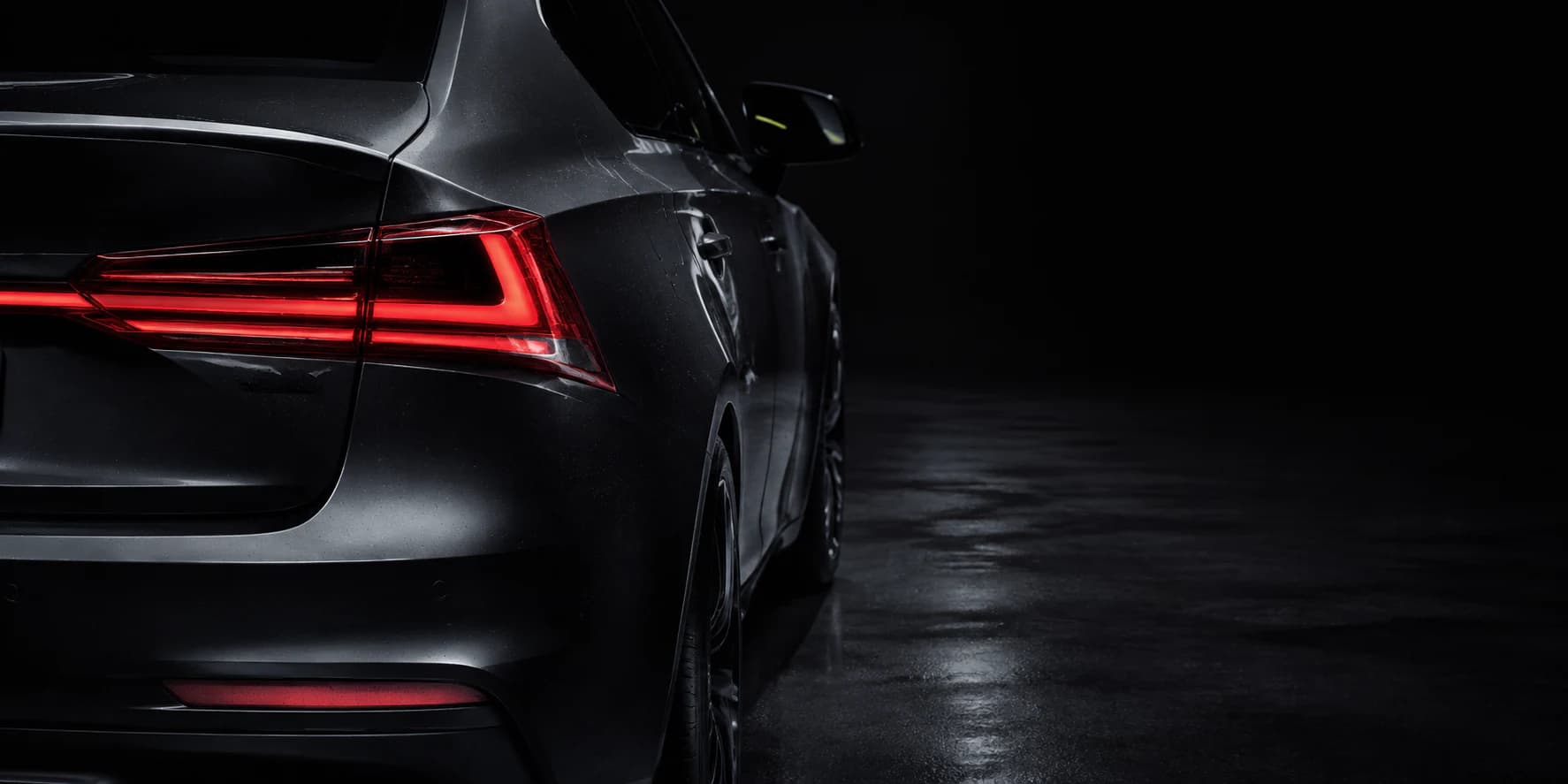 Rear detail of a modern car in a dark studio